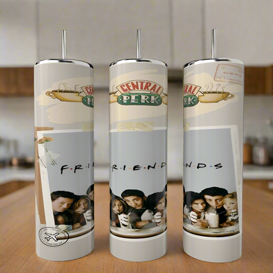 The Friends polaroid Tumblers by Kreative Kreationz, featuring a coffeehouse design and an image of six friends with milkshakes and "F.R.I.E.N.D.S" beneath, are crafted from stainless steel. These stylish pieces rest on a wooden surface in a cozy kitchen setting.