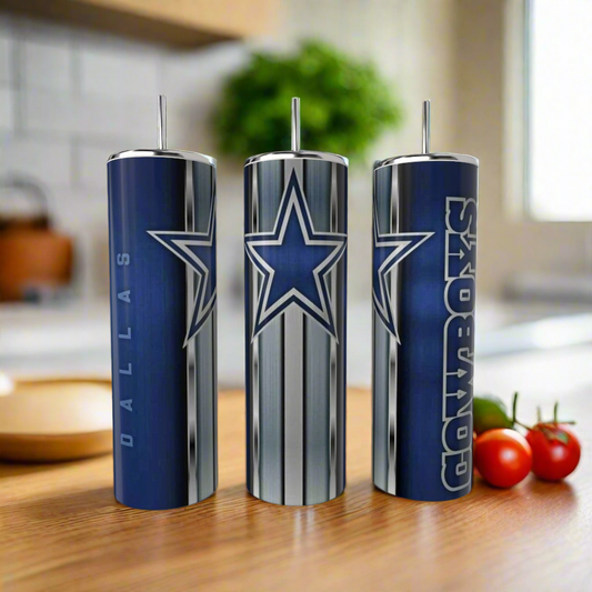 Three Kreative Kreationz Dallas Cowboys Stripe 20oz Tumblers with team logos and colors sit on a wooden kitchen counter, highlighting stylish, reusable drinkware. Tomatoes and other kitchen items are blurred in the background.
