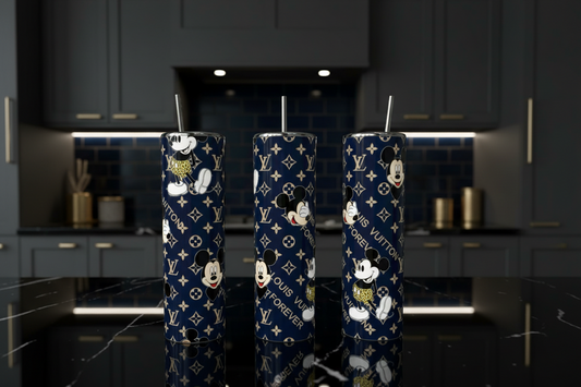 Three navy blue monogram tumblers with  Mouse prints, displayed on a black marble kitchen counter.
