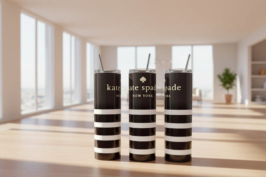 Three black and white striped tumblers with on a blurred background.