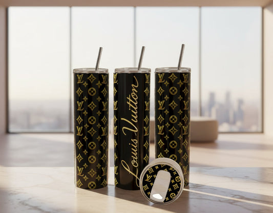 Three black tumblers with gold patterns and 'Louis Vuitton' branding on a kitchen counter.