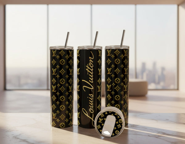 Three black tumblers with gold patterns and 'Louis Vuitton' branding on a kitchen counter.